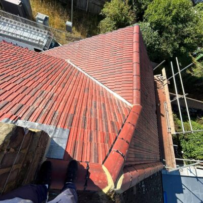 Red tiled roof with ridge tiles and lead flashing