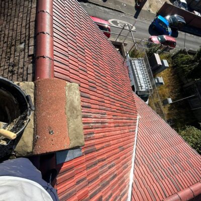 Red roof tiles with ridge caps and valley detailing
